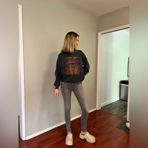 Black Anine Bing pullover with cheetah print detail and hot pink lettering.